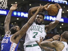 Boston Celtics guard Jaylen Brown (7) pulls down a rebound over Philadelphia 76ers center Amir Johnson (5) during the first quarter of Game 2 of an NBA basketball second-round playoff series Thursday, May 3, 2018, in Boston.