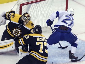 Tampa Bay Lightning center Brayden Point (21) scores against Boston Bruins goaltender Tuukka Rask (40) as Bruins defenseman Charlie McAvoy (73) watches in the first period of Game 4 of an NHL hockey second-round playoff series Friday, May 4, 2018, in Boston.