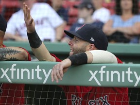 Boston Red Sox second baseman Dustin Pedroia gestures in the dugout before an interaleague baseball game against the Atlanta Braves at Fenway Park, Friday, May 25, 2018, in Boston. Pedroia is making his return after recovering from an injury.