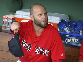 Boston Red Sox second baseman Dustin Pedroia speaks to teammates in the dugout before an interleague baseball game against the Atlanta Braves at Fenway Park, Friday, May 25, 2018, in Boston. Pedroia is making his return after recovering from an injury.
