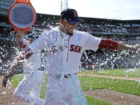 Boston Red Sox's Mookie Betts is drenched in a sports drink after their 5-4 victory over the Kansas City Royals in a baseball game at Fenway Park, Wednesday, May 2, 2018, in Boston. Betts hit three home runs in the game.