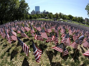 In this May 24, 2018 photo taken with a wide angle lens, flags are seen on Boston Common in Boston, which are placed there for Memorial Day. The solemn display of tens of thousands of U.S. flags that first appeared on Boston Common a decade ago to honor service members who have died defending the nation is slowly becoming a national movement. The flag gardens, as they are known, can be seen this weekend in Texas, Louisiana, Ohio and New York.