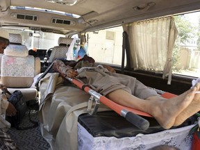 The body of a de-miner lies in an ambulance at a hospital in Kandahar, Afghanistan, Monday, May 21, 2018. An Afghan official said the Taliban killed at least five members of a demining team in an attack on Monday morning in the southern district of Maiwand. Zia Durrani, spokesman for the provincial police chief, said the de-miners were working for the TAPI national project, clearing a segment for a planned gas pipeline from central Asia that's headed to Pakistan and India through Afghanistan. (AP Photo)