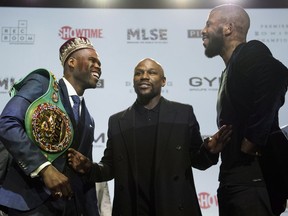 WBC light heavyweight title holder Adonis Stevenson, left to right, co-promoter Floyd Mayweather and challenger Badou Jack pose for a photo after a press conference at the Rec Room in Toronto, Thursday, May 17, 2018. Jack will challenge Stevenson for the WBC light heavyweight title on Saturday May 19, 2018 at the Air Canada Centre.