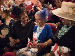 Yolanda McClean, left to right, her mother Melinda McClean and sister Sylvia McClean watch the Royal Wedding between Prince Harry and Meghan Markle at The Princess of Wales Theatre, in Toronto on Saturday, May 19, 2018.