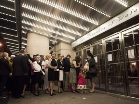 People line up to watch the Royal Wedding between Prince Harry and Meghan Markle at the Princess of Wales Theatre, in Toronto on Saturday, May 19, 2018.