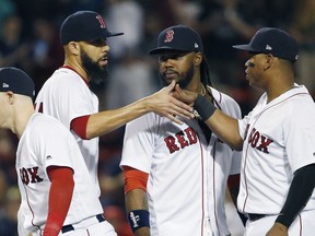 Boston Red Sox's David Price, second from left, celebrates with teammates, from left, Brock Holt, Hanley Ramirez and Rafael Devers after the Red Sox defeated the Baltimore Orioles 6-2 in a baseball game in Boston, Thursday, May 17, 2018.