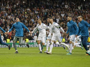 Real Madrid's Cristiano Ronaldo, center, celebrates with team mates after the Champions League semifinal second leg soccer match between Real Madrid and FC Bayern Munich at the Santiago Bernabeu stadium in Madrid, Spain, Tuesday, May 1, 2018.