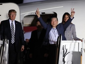 President Donald Trump and first lady Melania Trump greet former North Korean detainee Kim Dong Chul, raising his arms, upon his arrival with two other former detainees, Tony Kim and Kim Hak Song, behind Kim Dong Chul, Thursday, May 10, 2018, at Andrews Air Force Base, Md. The three Korean-Americans were greeted by Trump beneath a giant American flag after they returned to the mainland U.S. early Thursday.