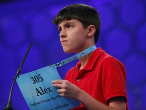 Alexander Christian, 11, from Saginaw, Mich., uses his name placard to spell his his word during the 2nd Round of the Scripps National Spelling Bee, Tuesday, May 29, 2018, in Oxon Hill, Md.