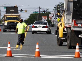 An emergency vehicle passes a roadblock near a scene where a Baltimore County police officer died, while investigating a suspicious vehicle, Monday, May 21, 2018, in Perry Hall, Md. Heavily armed police swarmed into the leafy suburb, searching for at least one armed suspect.