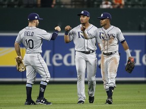 Tampa Bay Rays outfielders Johnny Field, Carlos Gomez and Mallex Smith, from left, fist-bump after the second baseball game of a doubleheader against the Baltimore Orioles, Saturday, May 12, 2018, in Baltimore. Tampa Bay won 10-3.