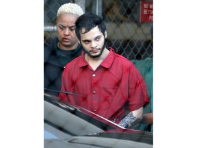 FILE- In this Jan. 30, 2017 file photo Esteban Santiago is escorted from the Broward County jail for an arraignment in federal court in Fort Lauderdale, Fla. Santiago pleaded guilty in exchange for a life prison sentence in the January 2017 Florida airport shooting that killed five people and wounded six.