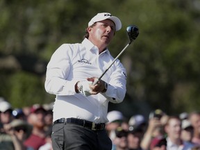 Phil Mickelson watches his shot from the 12th tee during the second round of The Players Championship golf tournament Friday, May 11, 2018, in Ponte Vedra Beach, Fla.