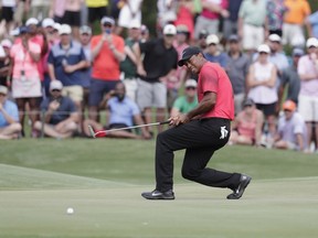 Tiger Woods reacts to a missed putt on the 11 green, during the final round of The Players Championship golf tournament, Sunday, May 13, 2018, in Ponte Vedra Beach, Fla.