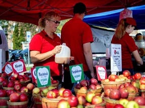 Country Mill Farms employees sell products on Sept. 17, 2017, at the East Lansing Farmer's Market in East Lansing, Mich.  Farmer Steve Tennes was banned last year by the city of East Lansing because it opposed his 2016 decision to not allow same-sex weddings at his commercial farm and orchard in Charlotte.  He returned to the market last fall for the final month and a half of the season after a federal district court judge issued a preliminary injunction against the city.  Starting Sunday, June 3, 2018, Tennes intends to sell The Country Mill's products.