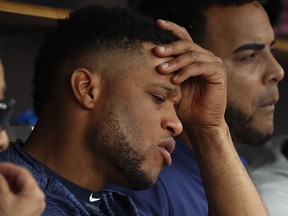 In this  Sunday, May 13, 2018 photo, Seattle Mariners' Robinson Cano sits on the bench against the Detroit Tigers in the fifth inning of a baseball game in Detroit. Seattle Mariners All-Star second baseman Robinson Cano has been suspended 80 games for violating baseball's joint drug agreement, Tuesday, May 15, 2018.