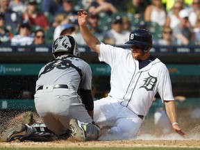 Detroit Tigers' John Hicks, right, is tagged out a home plate by Chicago White Sox catcher Alfredo Gonzalez on a fielder's choice in the fourth inning of a baseball game in Detroit, Saturday, May 26, 2018.
