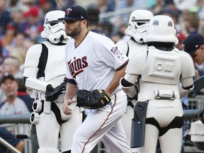 Minnesota Twins pitcher Lance Lynn heads to the mound as he takes the field past Star Wars characters during Star Wars Night at Target Field prior to the baseball game against the Detroit Tigers Tuesday, May 22, 2018, in Minneapolis.