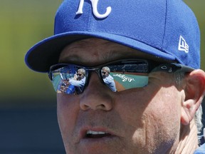 Kansas City Royals owner David Glass is reflected in the sunglasses of manager Ned Yost as they chat during batting practice before a baseball game against the Detroit Tigers at Kauffman Stadium in Kansas City, Mo., Saturday, May 5, 2018.
