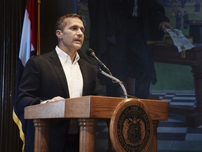 Missouri Gov. Eric Greitens reads from a prepared statement as he announces his resignation during a news conference, Tuesday, May 29, 2018, at the state Capitol, in Jefferson City, Mo. Greitens resigned amid a widening investigation that arose from an affair with his former hairdresser. Greitens said his resignation would take effect Friday.