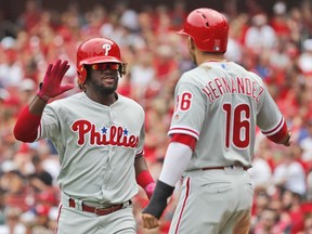 Philadelphia Phillies' Odubel Herrera, left, is congratulated by teammate Cesar Hernandez after hitting a two-run home run during the third inning of a baseball game against the St. Louis Cardinals, Saturday, May 19, 2018, in St. Louis.