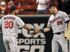 Minnesota Twins' Max Kepler (26) and Eddie Rosario celebrate following a baseball game against the St. Louis Cardinals Monday, May 7, 2018, in St. Louis. The Twins won 6-0.