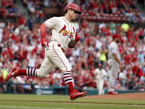 St. Louis Cardinals' Tyler O'Neill rounds the bases after hitting a solo home run off Philadelphia Phillies relief pitcher Luis Garcia, right, during the sixth inning of a baseball game Saturday, May 19, 2018, in St. Louis.