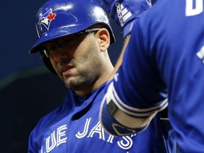 Kendrys Morales of the Toronto Blue Jays gets congratulations from a teammate after hitting one of his two homers on the night in a 7-4 victory over the Minnesota Twins Tuesday in Minneapolis.