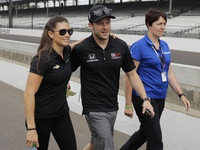 Danica Patrick and Marco Andretti walk to the drivers meeting for the Indianapolis 500 auto race at Indianapolis Motor Speedway, in Indianapolis Saturday, May 26, 2018.