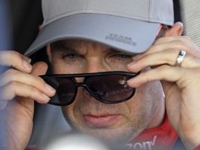 Will Power, of Australia, looks at the results from a practice session for the IndyCar Grand Prix auto race at Indianapolis Motor Speedway, in Indianapolis Friday, May 11, 2018.