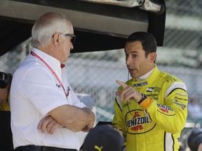 Car owner Roger Penske, left, listens to Helio Castroneves, of Brazil, during the final practice session for the IndyCar Indianapolis 500 auto race at Indianapolis Motor Speedway, in Indianapolis Friday, May 25, 2018.