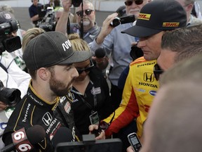 Ryan Hunter-Reay, right, talks with James Hinchcliffe, of Canada, after Hinchcliffe did not qualify for the IndyCar Indianapolis 500 auto race at Indianapolis Motor Speedway in Indianapolis, Saturday, May 19, 2018.