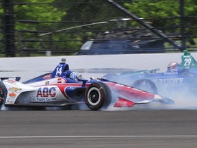 Tony Kanaan (14), of Brazil, slides by Carlos Munoz, of Colombia, after losing control of his car during the Indianapolis 500 auto race at Indianapolis Motor Speedway in Indianapolis, Sunday, May 27, 2018.