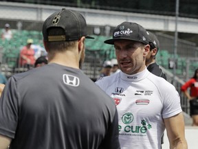 James Hinchcliffe, left, of Canada, talks with Jay Howard, of England, during qualifications for the IndyCar Indianapolis 500 auto race at Indianapolis Motor Speedway, in Indianapolis Sunday, May 20, 2018.