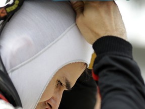 Robert Wickens, of Canada, puts on his helmet before qualifying for the IndyCar Indianapolis 500 auto race at Indianapolis Motor Speedway, in Indianapolis Sunday, May 20, 2018.