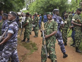 Army soldiers and policemen attend the scene where more than 20 people were killed in their homes in an overnight attack in the Ruhagarika community of the rural northwestern province of Cibitoke, in Burundi Saturday, May 12, 2018.  More than twenty people were killed and others wounded in the attack, the country's security minister said Saturday, calling it the work of a "terrorist group" he did not identify.