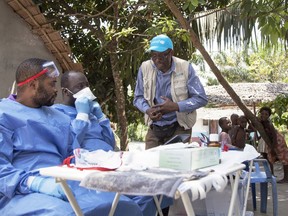 In this photo taken Friday, May 25, 2018, UNICEF staffer Jean Claude Nzengu, center, talks with members of an Ebola vaccination team as they prepare to administer the vaccine in an Ebola-affected community in the north-western city of Mbandaka, in Congo. An Ebola vaccination campaign is under way in Mbandaka, the city of 1.2 million on the Congo River where four Ebola cases have been confirmed.