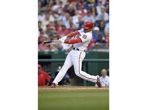 Washington Nationals' Juan Soto follows through on his three-run home run during the second inning of a baseball game against the San Diego Padres, Monday, May 21, 2018, in Washington. This was his first major league hit.