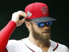 Washington Nationals' Bryce Harper wear glasses before the first baseball game of a doubleheader against the Los Angeles Dodgers at Nationals Park, Saturday, May 19, 2018, in Washington.