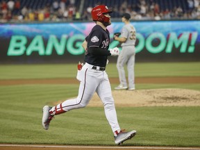 Washington Nationals' Bryce Harper circles the bases after hitting a three-run homer off Pittsburgh Pirates starting pitcher Chad Kuhl, rear, during the fifth inning of a baseball game at Nationals Park, Tuesday, May 1, 2018, in Washington.
