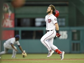 Washington Nationals' Bryce Harper loses his helmet as he runs towards second on his double during the second inning of a baseball game against the San Diego Padres, Monday, May 21, 2018, in Washington.