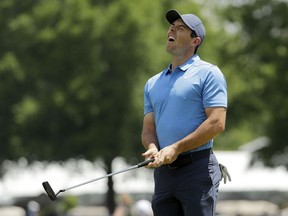 Rory McIlroy, of Northern Ireland, reacts to missing a putt on the second hole during the final round of the Wells Fargo Championship golf tournament at Quail Hollow Club in Charlotte, N.C., Sunday, May 6, 2018.