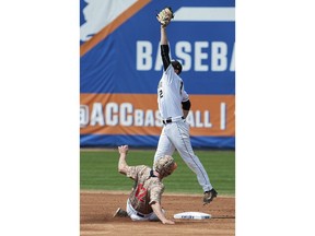 FILE - In this May 27, 2016, file photo, Virginia's Charlie Cody slides safely into second base under Wake Forest's Johnny Aiello during the second inning of an Atlantic Coast Conference college baseball tournament game in Durham, N.C. The Atlantic Coast Conference baseball tournament is back in central North Carolina after a year away.