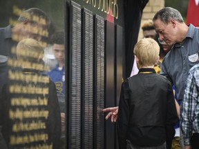 Hank Black touches his son's, Staff Sgt. Bryan Black, name plate on the memorial wall during the U.S. Army Special Operations Command Fallen Special Operations Soldier Memorial ceremony on Thursday, May 24, 2018, on Fort Bragg, N.C. Staff Sgt. Black died on Oct. 4, 2017, from small arms fire while deployed in Niger.