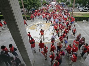 Participants make their way into the Legislative Building during a teachers rally at the General Assembly in Raleigh, N.C., Wednesday, May 16, 2018. Thousands of teachers rallied the state capital seeking a political showdown over wages and funding for public school classrooms.
