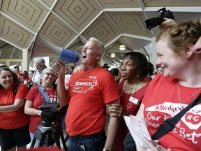 Mark Jewell, president of the North Carolina Association of Educators asks teachers to refrain from chanting and causing a disturbance outside the House and Senate chambers during a teachers rally at the General Assembly in Raleigh, N.C., Wednesday, May 16, 2018. Thousands of teachers rallied the state capital seeking a political showdown over wages and funding for public school classrooms.