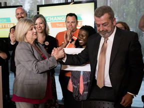 Ontario NDP Leader Andrea Horwath shakes hands with Elementary Teachers' Federation of Ontario president Sam Hammond in Toronto on May 10, 2018.