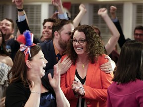 Democratic 2nd District House candidate Kara Eastman is hugged by her campaign manager Ben Onkka, in Omaha, Neb., Tuesday, May 15, 2018, as she holds a slim lead over Brad Ashford in the primary election. Omaha-area voters are set to pick a Democratic nominee Tuesday who will challenge U.S. Rep. Don Bacon, R-Neb., after the congressman claimed the seat from Democrats two years ago.