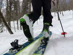 In this Saturday, April 21, 2018, photo, provided by Andrew Drummond, Drew Zimber "skins" uphill using backcountry skis with climbing skins attached to the base, on Crescent Ridge in the Randolph Community Forest in Randolph, New Hampshire. Ski boots pivot in a front binding for the ascent. Skiers remove the skins and lock their heels down in the rear binding for the descent.